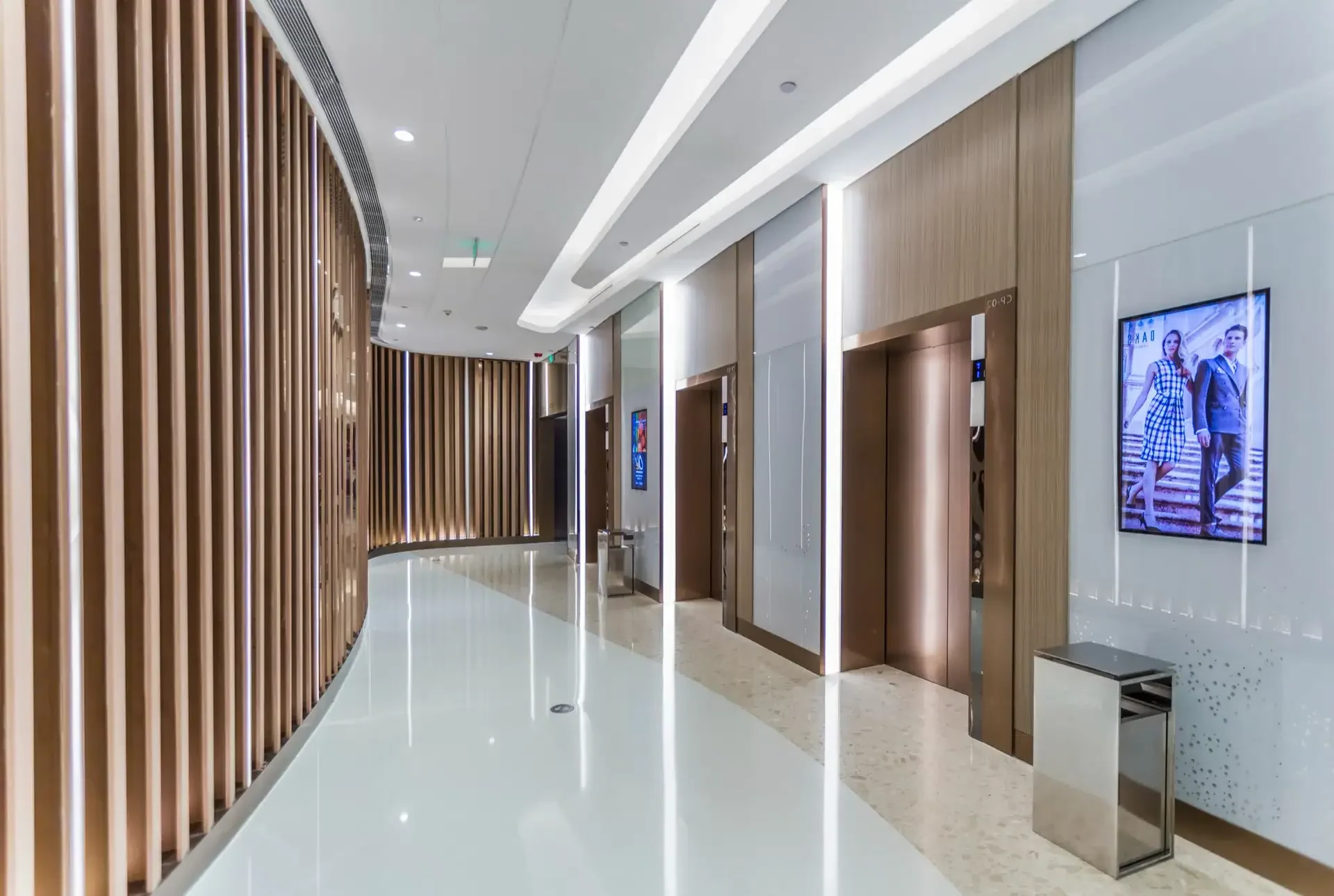 white hallway with wooden clad wall and elevators