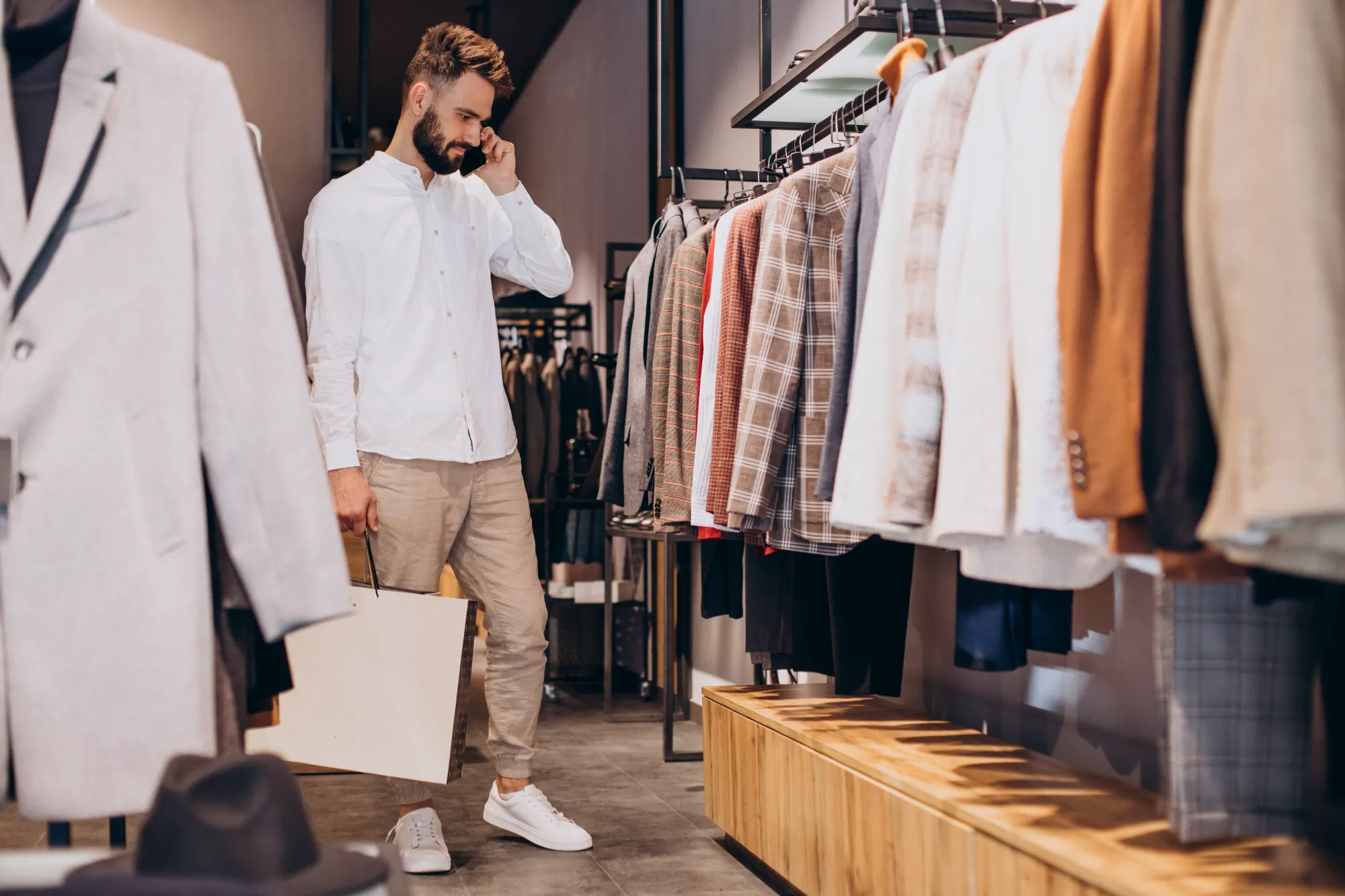 young-man-shopping-menswear-store-talking-phone